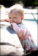 baby standing by wall at brookside gardens