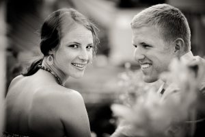 A black and white portrait of a man and woman smiling during their engagement photo session in downtown Annapolis.