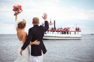 Bride waiving at boat naval academy