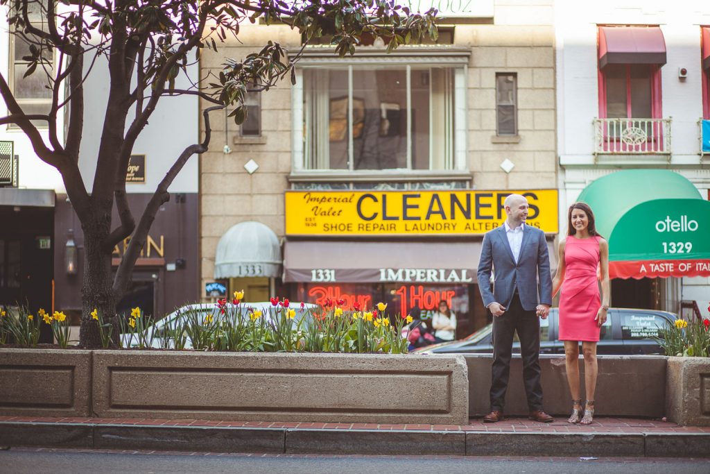 Engaged couple waiting to cross the street.