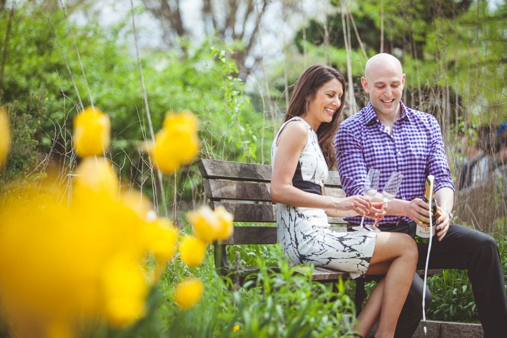 The color purple color in the shirt complements the scene's predominantly green color.