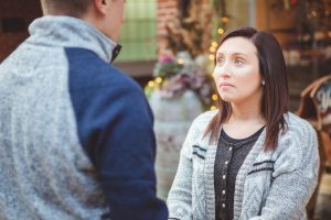 A man and woman sharing a meaningful glance in front of a downtown Annapolis store.