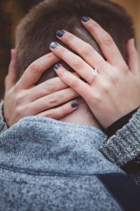 A man with a ring on his hand is captured in a compelling portrait.