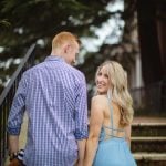 An engagement portrait of a couple holding hands on the steps of a downtown Annapolis building.