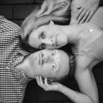 A black and white engagement photo of a couple laying on the ground in Downtown Annapolis.