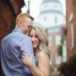 A couple embraces in front of the capitol building for their engagement photo.