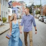 An engaged couple walking down a street in Downtown Charlottesville, Virginia.