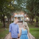 An engaged couple having an Engagement Session in Downtown Annapolis, holding hands on a brick walkway for their Portrait.