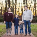 A family enjoys a peaceful evening at Quiet Waters Park during their engagement session.