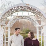 A couple holding hands under a gazebo in Quiet Waters Park.