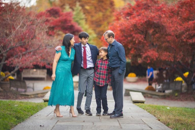 A family poses for a photo in Brookside Gardens, Wheaton, Maryland.