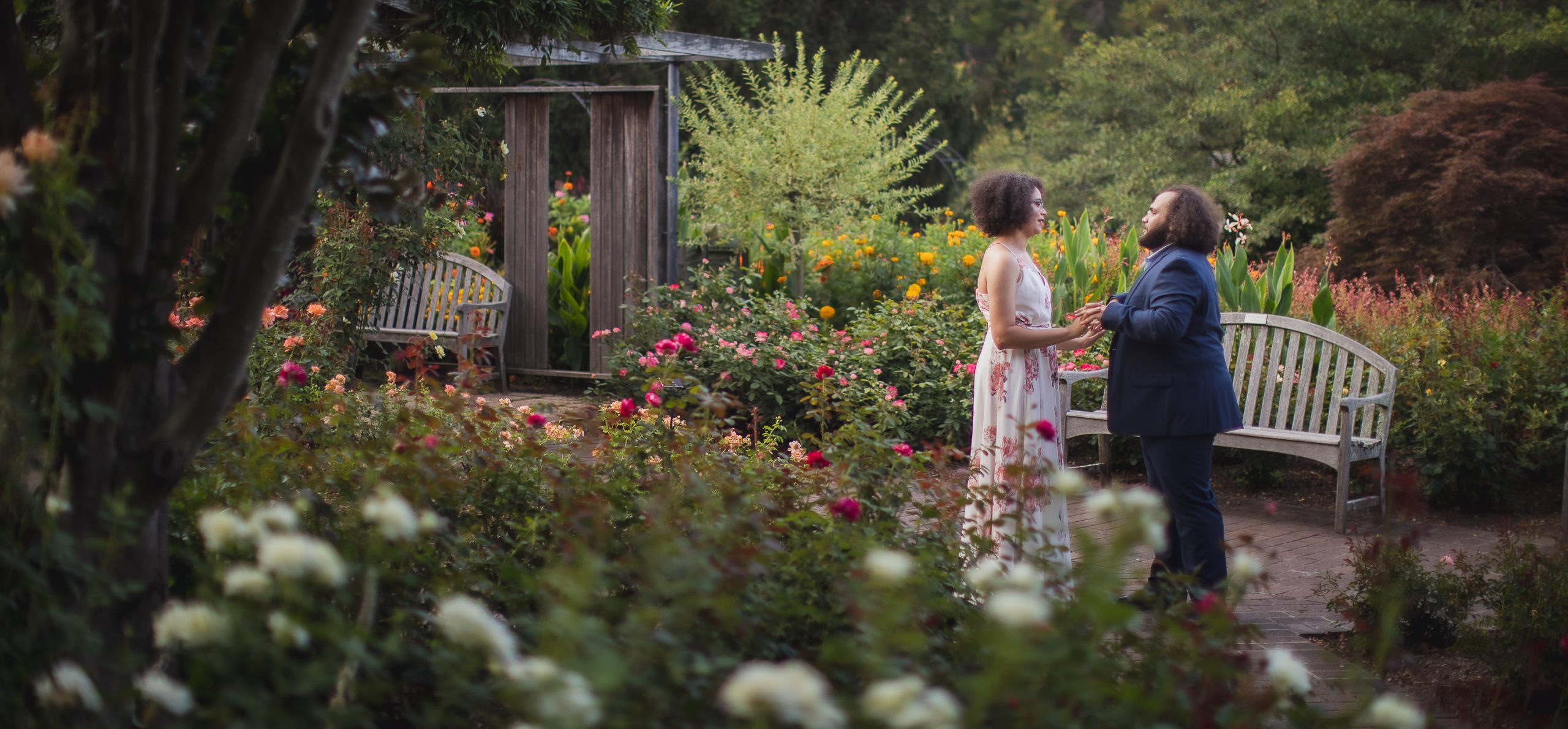 A bride and groom standing in Brookside Gardens.