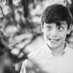 A black and white portrait of a boy in Federal Hill Park.