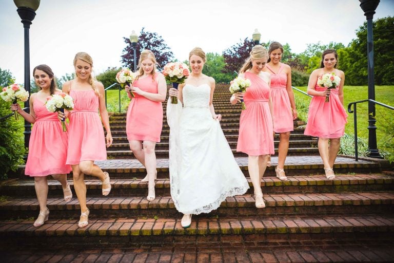 A bride and her bridesmaids are walking down the stairs at Quiet Waters Park in Annapolis, Maryland.