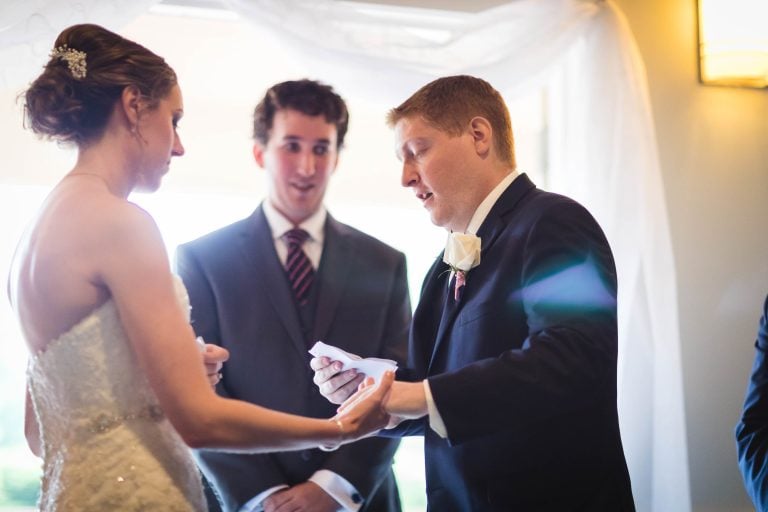 In the picturesque setting of Quiet Waters Park in Annapolis, Maryland, a bride and groom are exchanging their wedding vows.