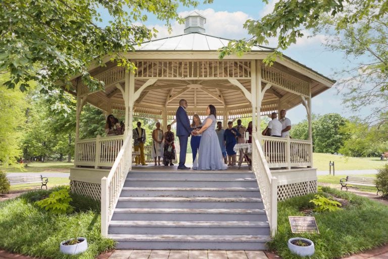 A bride and groom standing in front of a gazebo at Quiet Waters Park, Annapolis.