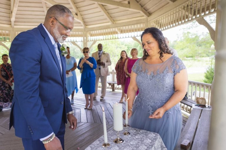 A couple lighting a candle in a gazebo at Quiet Waters Park in Annapolis, Maryland.