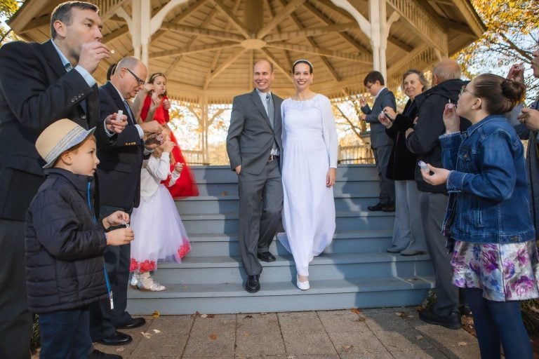 A bride and groom walking down the steps of a gazebo at Quiet Waters Park in Annapolis, Maryland.