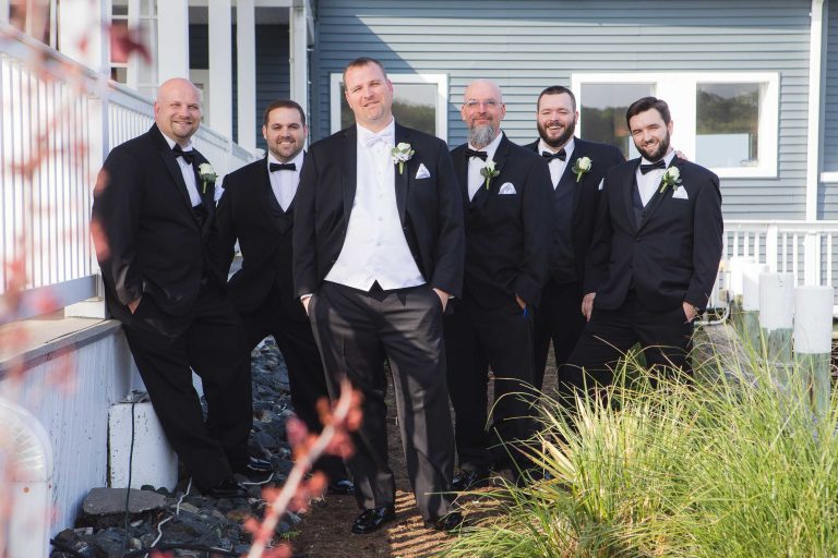 A group of groomsmen posing in front of a house in Annapolis, Maryland.