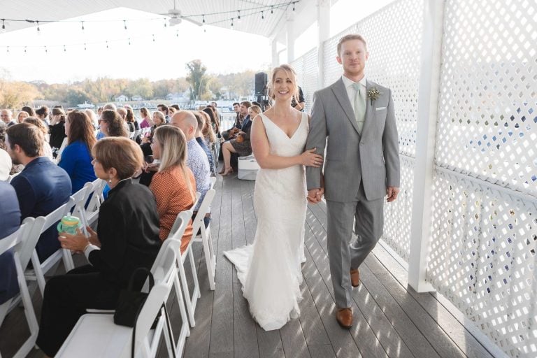 A bride and groom walking down the aisle at the Anchor Inn in Maryland for their wedding ceremony in Annapolis.