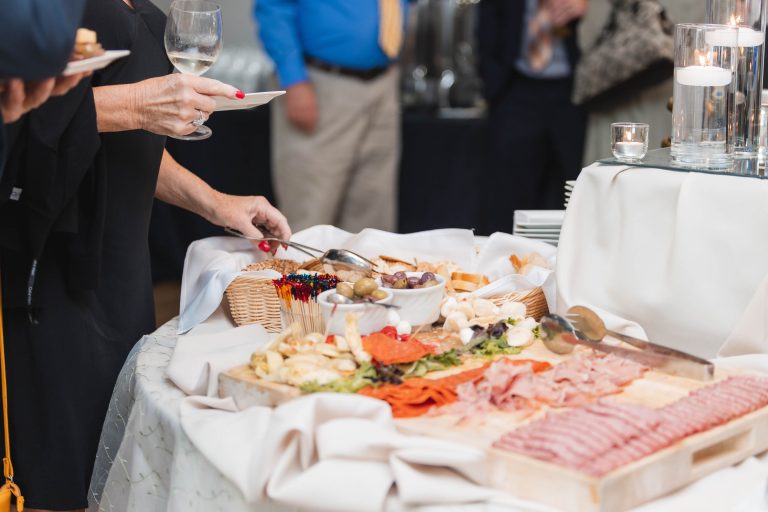 A group of people serving food at the Anchor Inn wedding reception in Annapolis, Maryland.