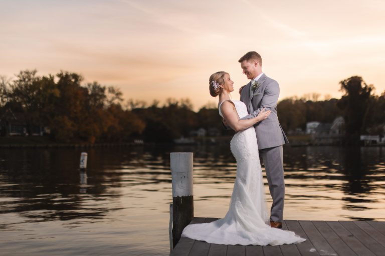 A bride and groom standing on a dock at Anchor Inn in Annapolis.