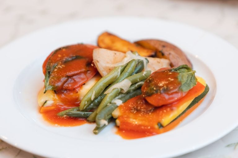 A plate with vegetables and sauce on it at Anchor Inn in Maryland.