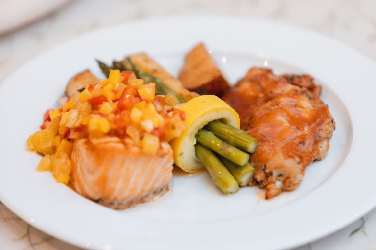 A plate with salmon, asparagus, and other food at Anchor Inn in Annapolis, Maryland.