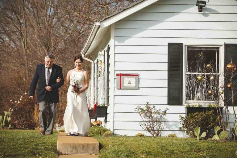 A bride and her father walking down the steps of Annapolis Wedding Chapel in Annapolis, Maryland.