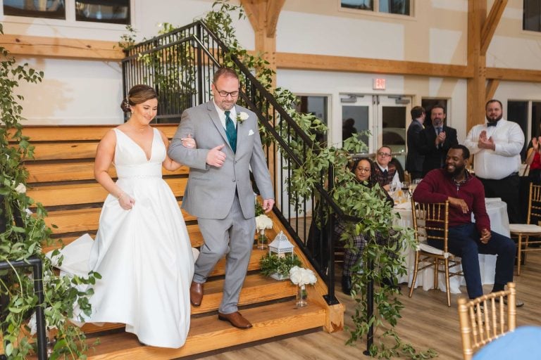 A bride and groom walking down the stairs at their wedding in Annapolis.