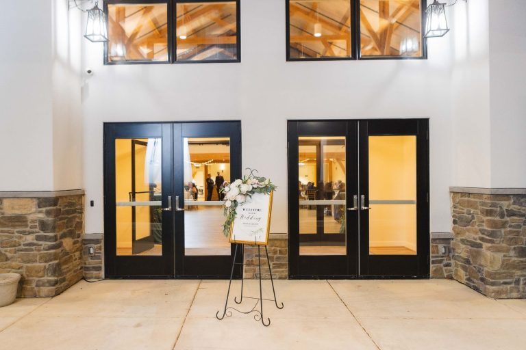 The entrance to the Atreeum at Soaring Timbers building in Annapolis, Maryland, featuring two doors and a sign.