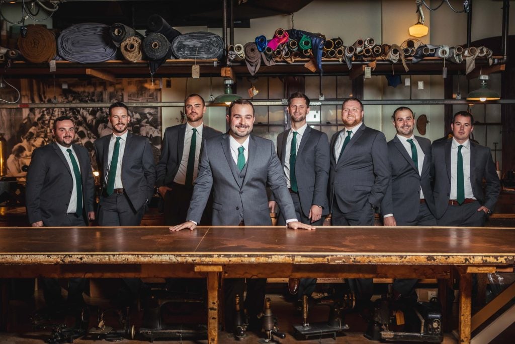 A group of men in suits posing at the Baltimore Museum of Industry.