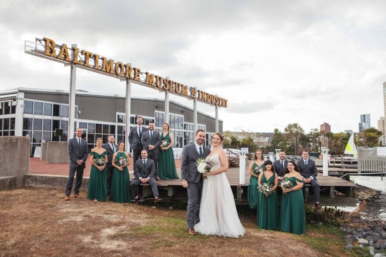 The bride and groom pose for a photo in front of the Baltimore Museum of Art in Baltimore, Maryland.