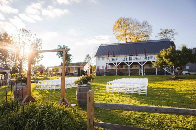 A wedding ceremony set up in a field at the Barns at Hamilton Station Vineyards.