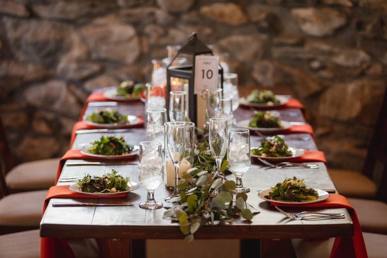 A wooden table is set with plates and napkins at Barns at Hamilton Station Vineyards in Virginia.