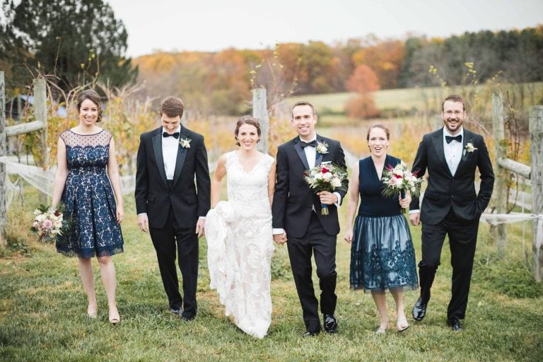 A group of bridesmaids and groomsmen walking in the Barns at Hamilton Station Vineyards in Virginia.