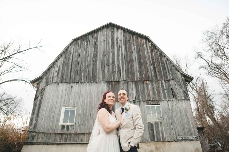 A bride and groom posing at Barns at Hamilton Station Vineyards in Virginia.