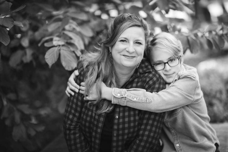 A black and white photo of a woman hugging her son in Washington DC.