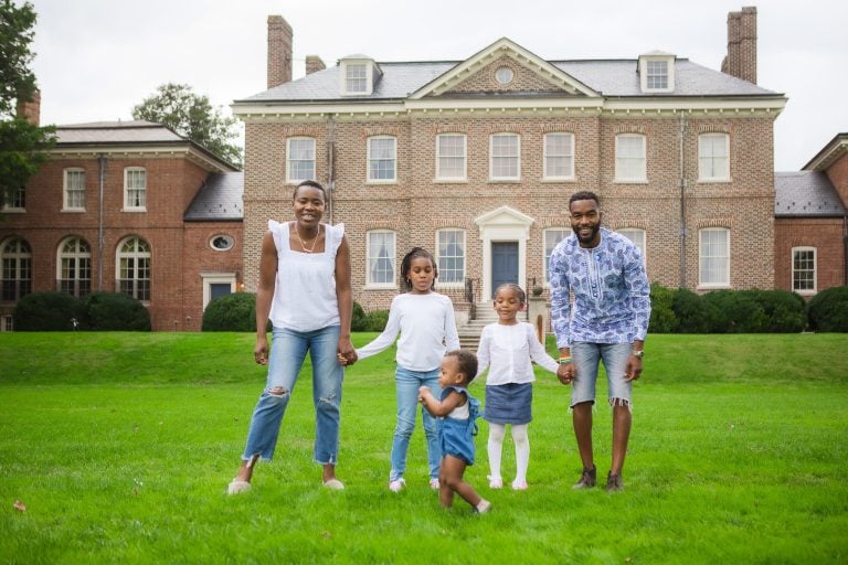 A family standing in front of a large brick house in Bowie, Maryland.