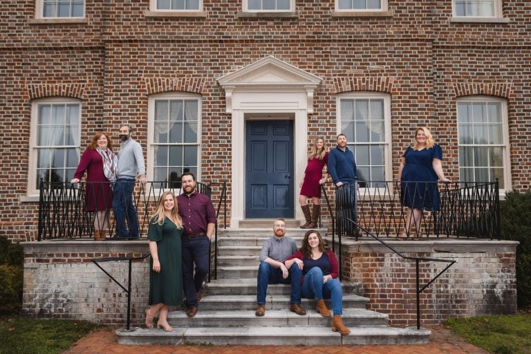 A group of people posing on the steps of Belair Mansion in Bowie, Maryland.