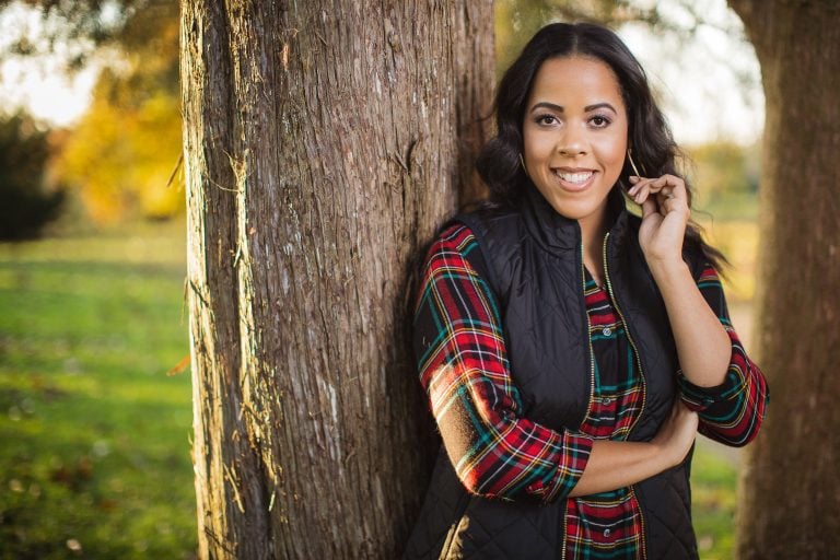 A black woman leaning against a tree in Bowie, Maryland.