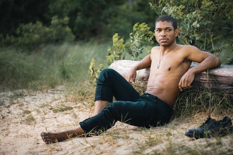 A man sitting on a log at Beverly Triton Nature Park in Maryland.