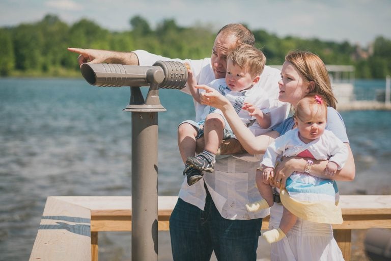 A family is looking through a binocular at Black Hill Regional Park in Germantown, Maryland.