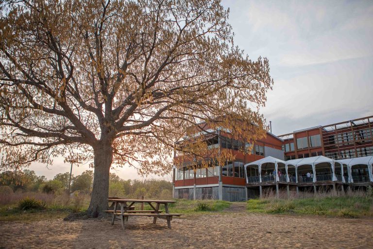 A large building in Annapolis, Maryland with a picnic table in front of it.