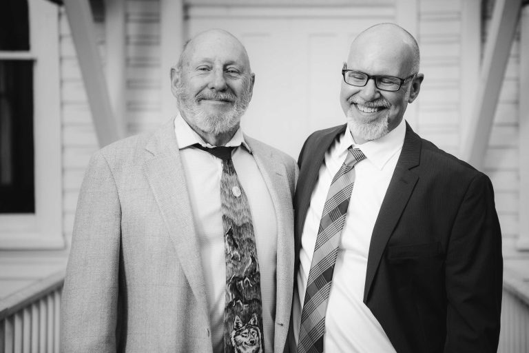 Two men in suits standing next to each other at Dorsey Chapel, Glenn Dale, Maryland.