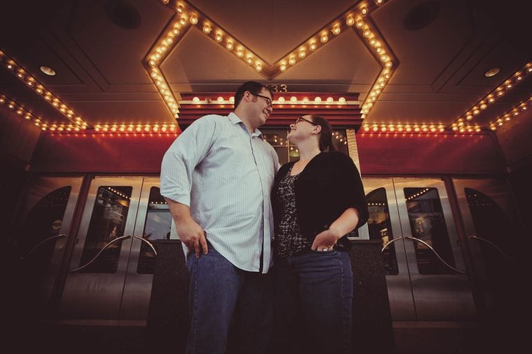 A couple standing in front of a theater in Downtown Silver Spring.