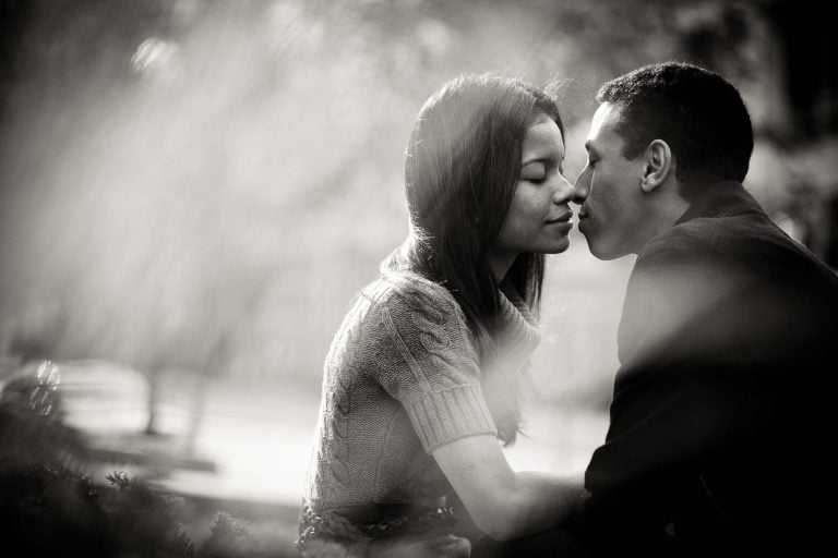 A black and white photo of a couple kissing in Downtown Silver Spring.