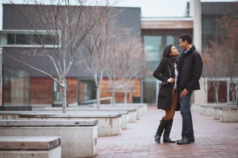 An engaged couple standing in front of a building in Downtown Silver Spring, Maryland.