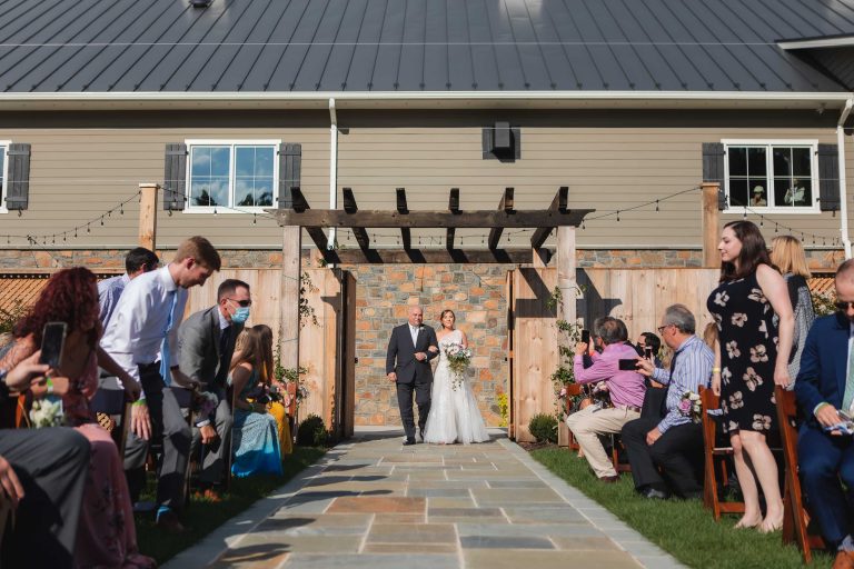 A bride and groom walking down the aisle at an outdoor wedding in Leesburg, Virginia.