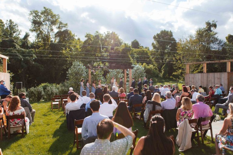 A Virginia wedding ceremony at Fleetwood Farm Winery in Leesburg with a large group of people.